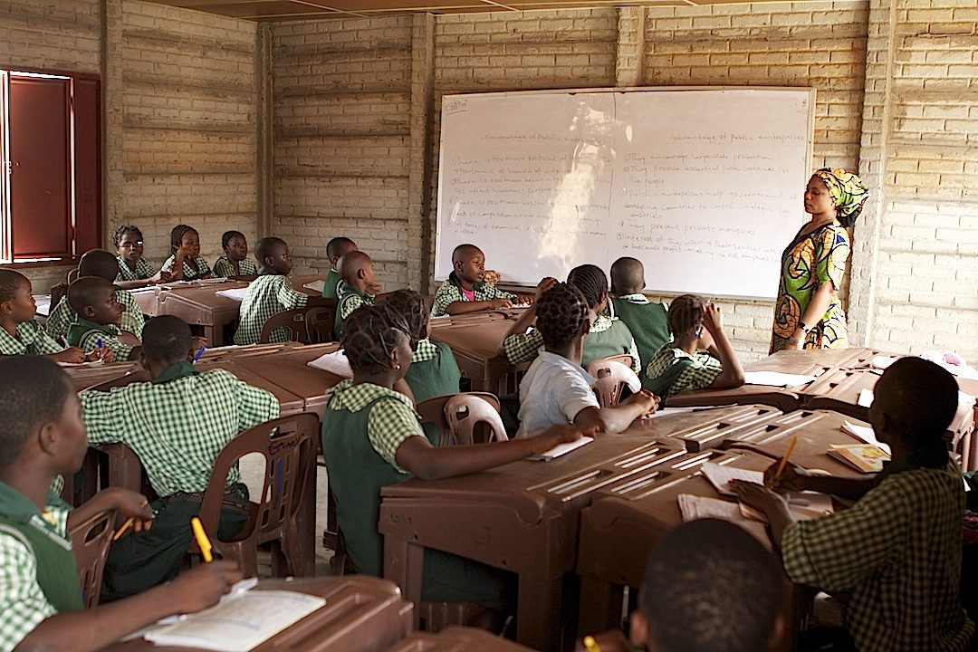 Nigerian pupils learning together in a bright classroom